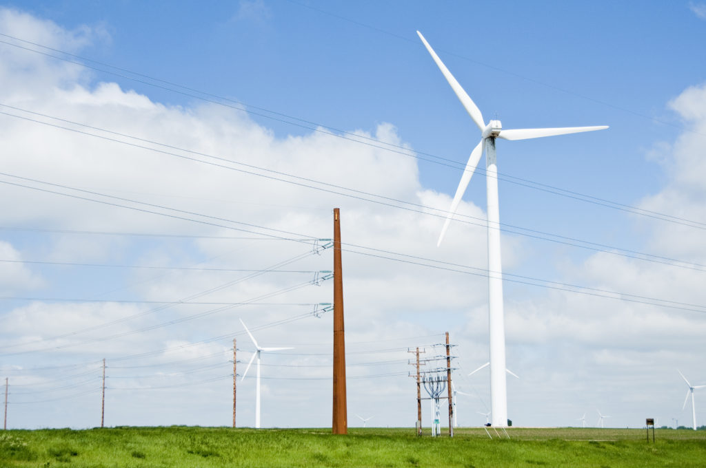 wind turbines and electric transmission lines located on a farm